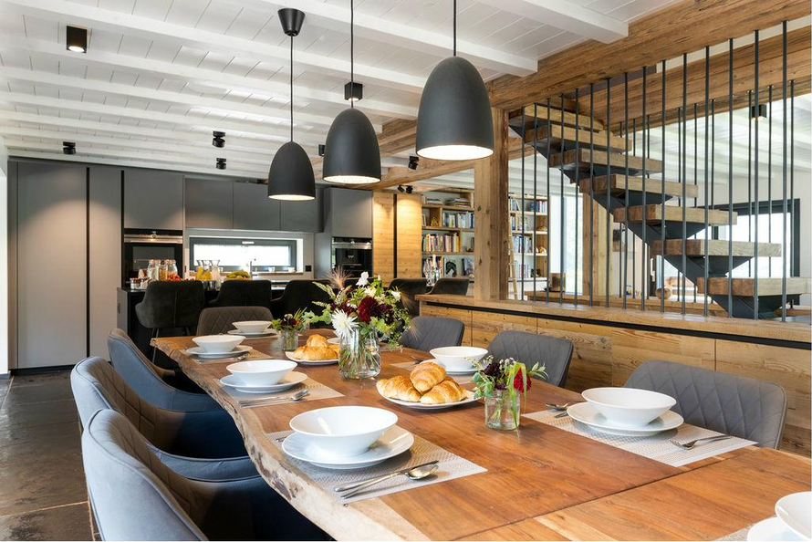 Kitchen and long dining table under pendant lights