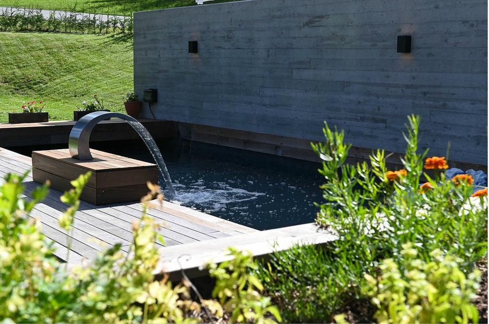 Pool waterfall and summer flowers on the deck